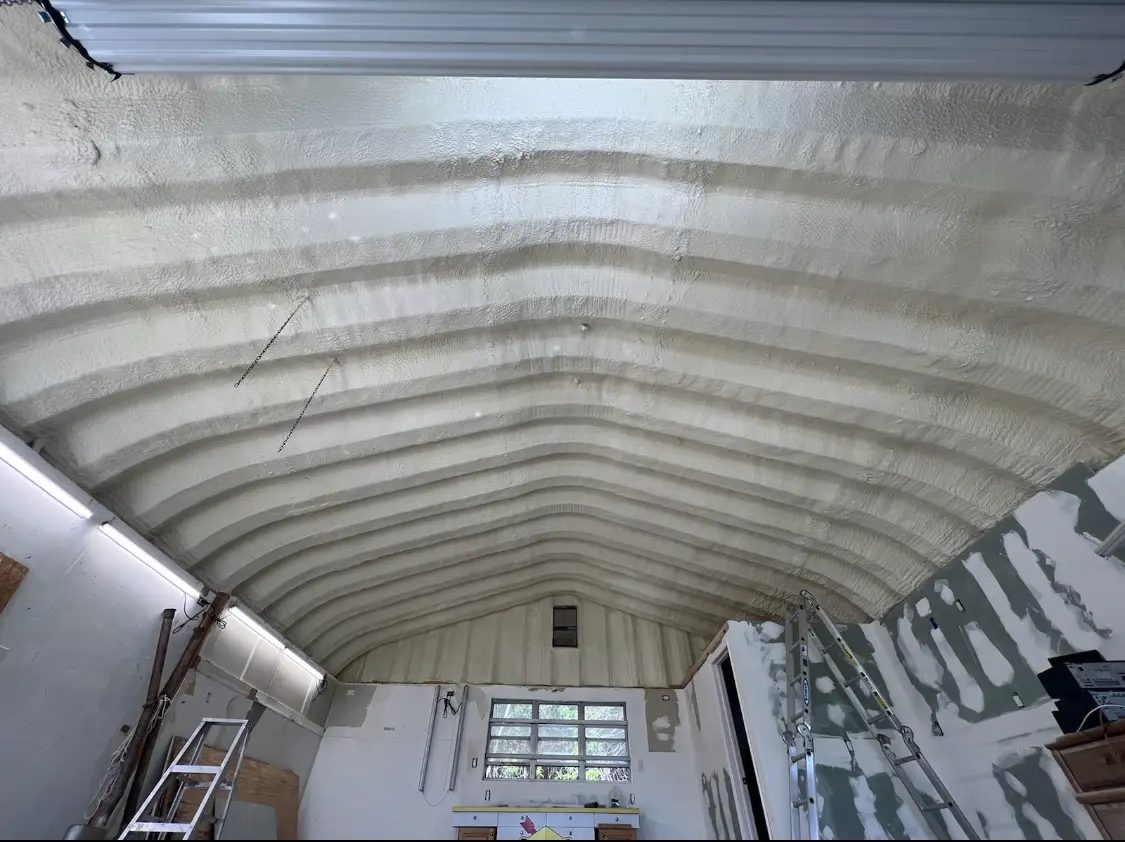 Spray polyurethane foam applied to the underside of a metal roof deck in Gary